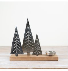 A set of three Christmas trees on a wooden base complete with a t-light holder
