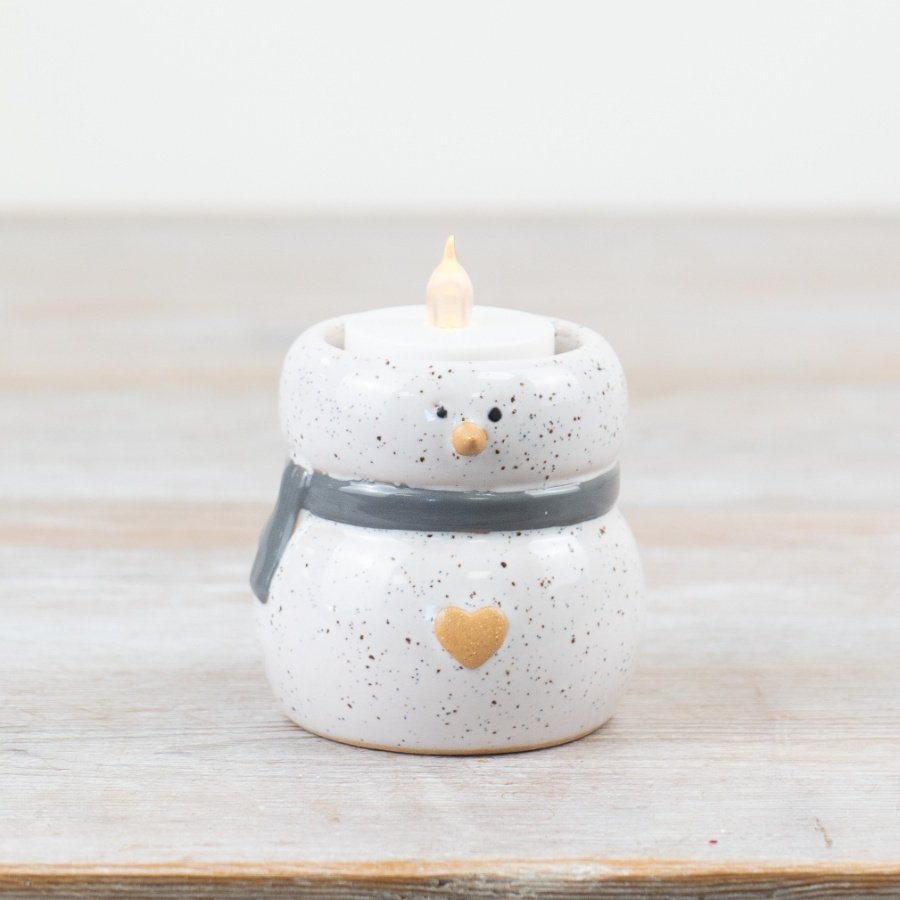 A charming snowman decoration with a speckled glaze. Beautifully detailed and unique. A must have t-light holder