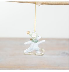 A unique decoration featuring a candy cane snowboarding mouse with festive hat and scarf.