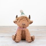 Bring a touch of countryside charm into your home with our charming Sitting High Land Cow figurine. 