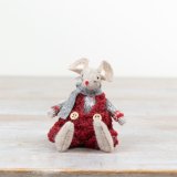 An adorable little sitting fabric mouse complete with deep red dungarees.