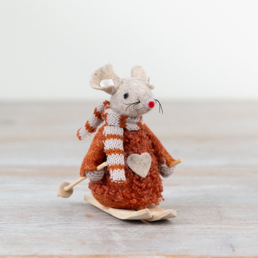 A charming felt mouse decoration in a rich orange hue with knitted scarf and wooden skis. 