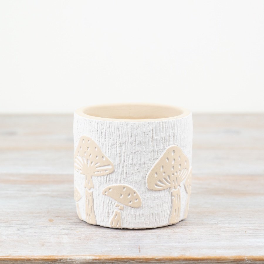 Elevate your plant pot collection with this charming white planter adorned with whimsical cream embossed mushroom