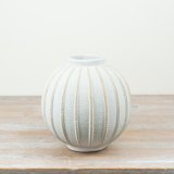 a sleek textured white vase 