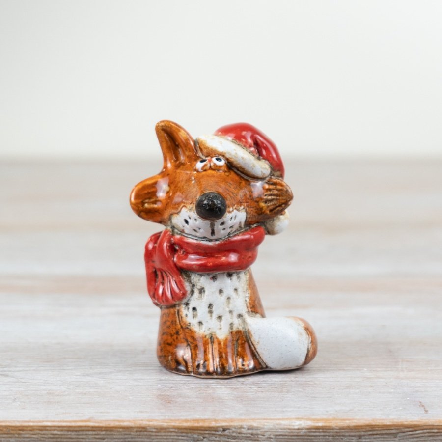 A beautifully crafted and characterful fox ornament in a rich amber colour. Decorated with a reactive glaze. 