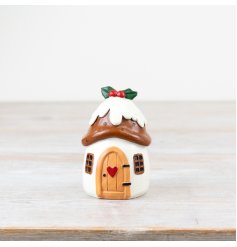 Add a touch of charm to your holiday decor with this charming Christmas pudding house decoration.