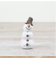 A rustic snowman ornament with a handmade aesthetic and textured surface. A unique and loveable addition to the home. 