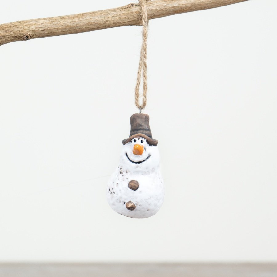 A beautifully crafted and hand finished snowman ornament with a rustic aesthetic and jute string hanger. 