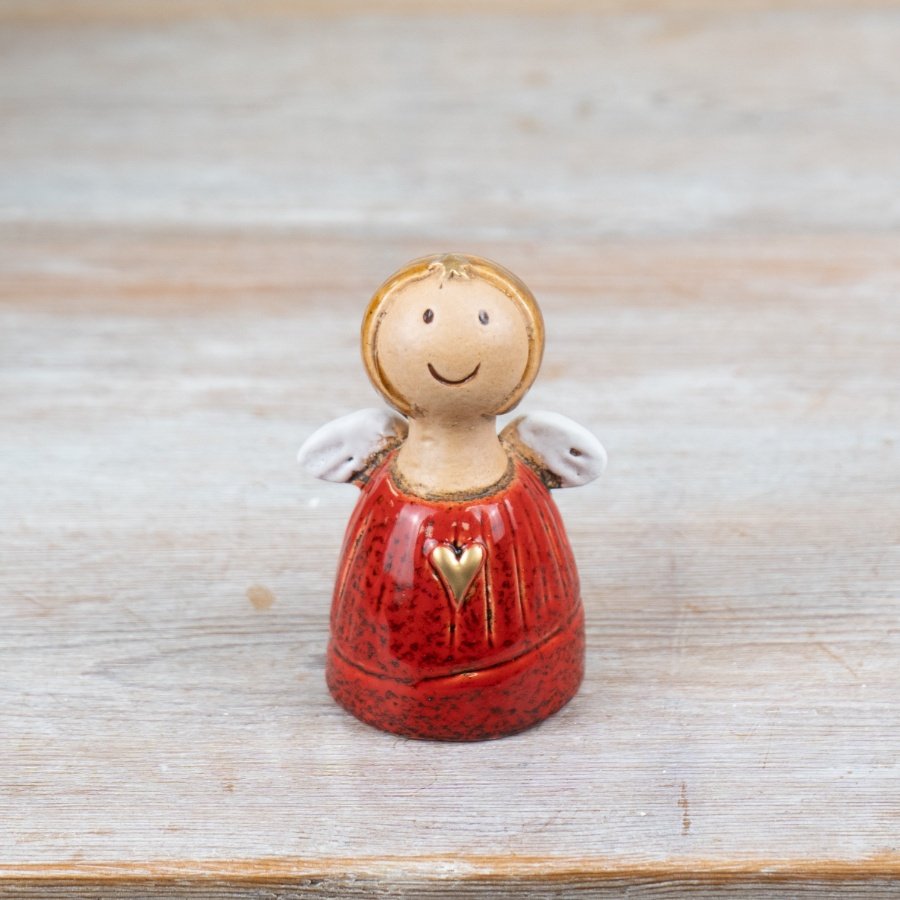 A charming angel decoration with a gold painted heart and a rich red glaze.