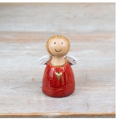 A charming hand finished angel decoration. Beautifully glazed and richly coloured with a gold heart detail. 