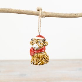 A beautifully crafted highland cow hanger with Christmas hat and scarf.