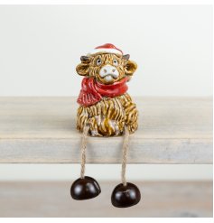 A charming and original highland cow shelf sitter. Hand finished and complete with festive details. 