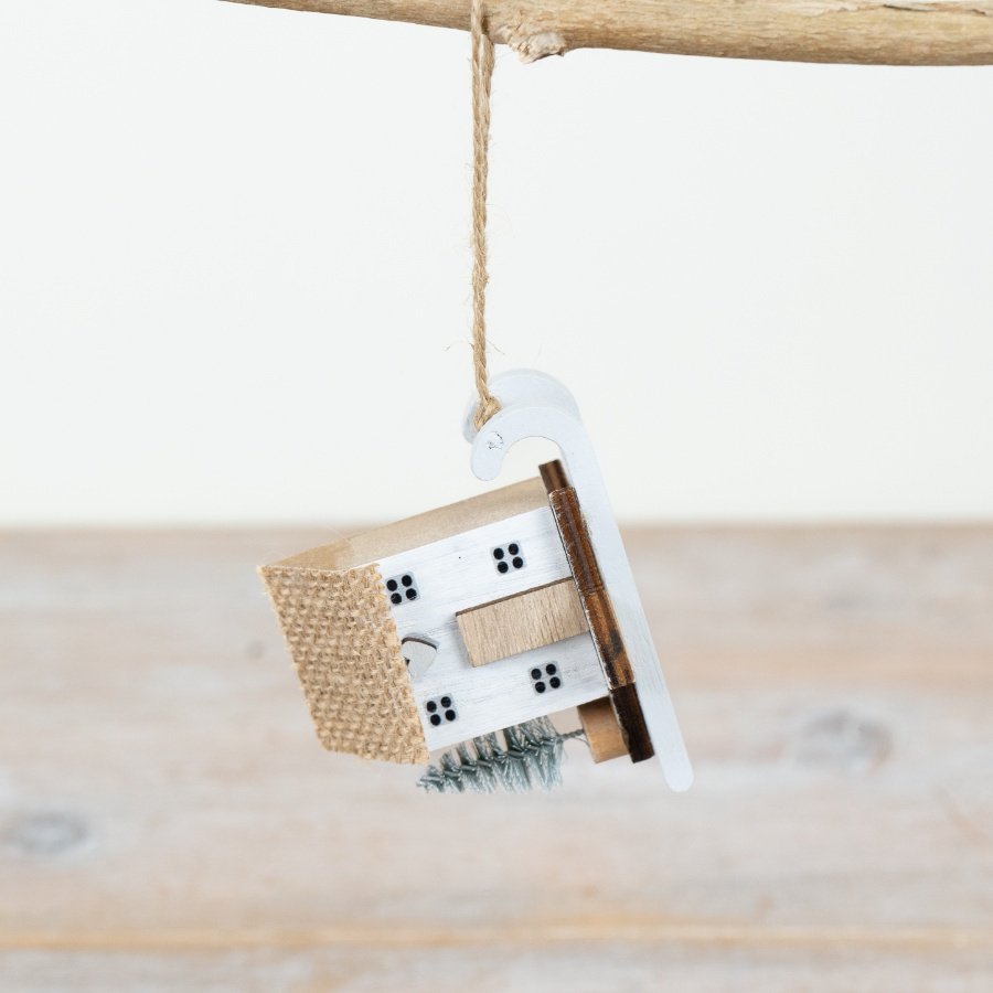 Infuse rustic charm into your home with our Hanging Wooden House decoration.