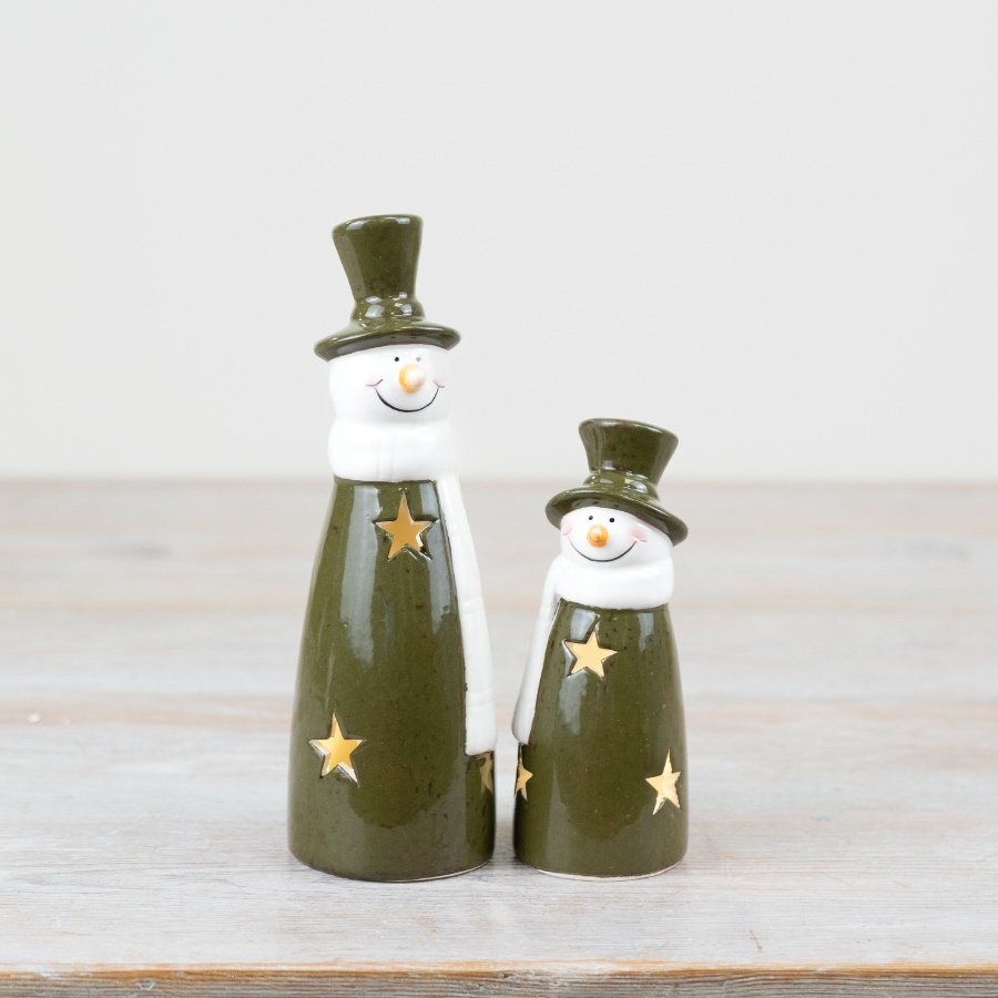 Brighten up your holiday décor with this mischievous light-up snowman in a vibrant shade of green! 