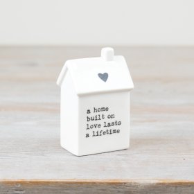Add charm to your home with this petite white house ornament. Perfect for any style. 