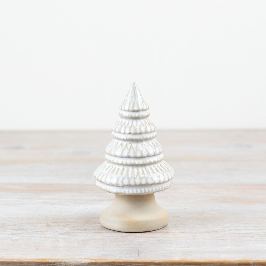 Elegant natural glazed porcelain tree ornament with delicate pattern, resting on unglazed base.