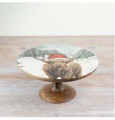 A stunning wooden cake stand featuring a festive highland cow woodland scene.