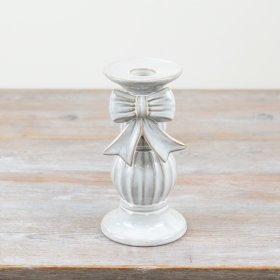 An exquisite ceramic candle holder, adorned with a charming bow and coated in a beautiful natural white glaze. 