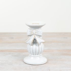 A stunning ceramic candle holder adorned with a beautiful bow. 