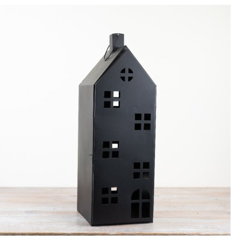 Display a charming look with this lantern-style candle holder featuring a charming rustic house design.