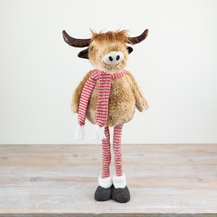 Introducing our delightful highland cow standing ornament, complete with red and white striped extendable legs