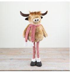 Introducing our delightful Highland cow figurine, complete with charming red striped extendable legs and a cosy scarf.