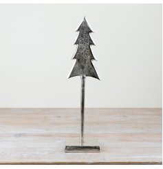 A beautiful Christmas tree on a metal stand.