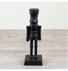 Add a touch of traditional charm to any festive decor with this elegant nutcracker ornament.