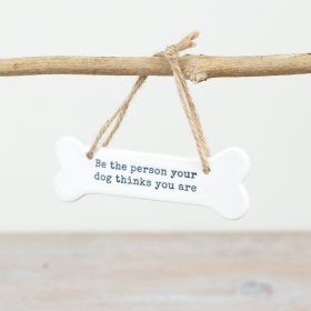 Infuse your home with dog-inspired decor with our charming bone-shaped hanging sign: 'Be the Person Your Dog Be