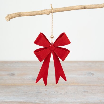 Add a classic touch to any holiday decorations with this elegant red metal bow hanger.