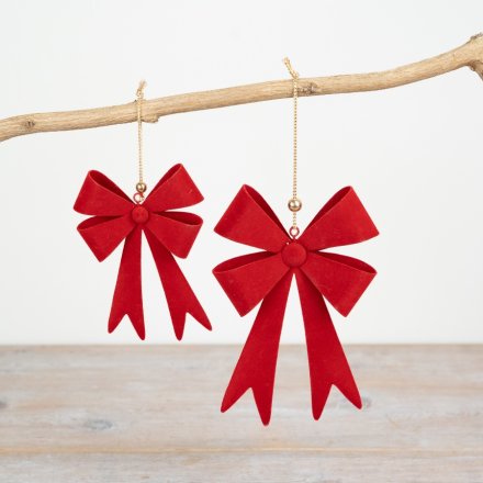 A red metal bow hanger complete with a velvet finish and gold string. 
