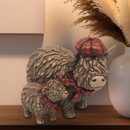 Bring home a piece of the Scottish countryside with our charming Highland Cow and Baby Ornament. 