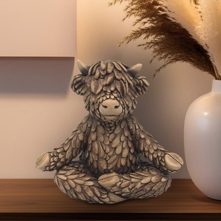 Find your zen with the serene Yoga Hughie Highland Cow Ornament, a beautiful bronze addition to any home.
