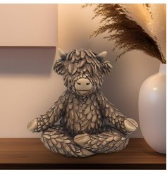 Find your zen with the serene Yoga Hughie Highland Cow Ornament, a beautiful bronze addition to any home.