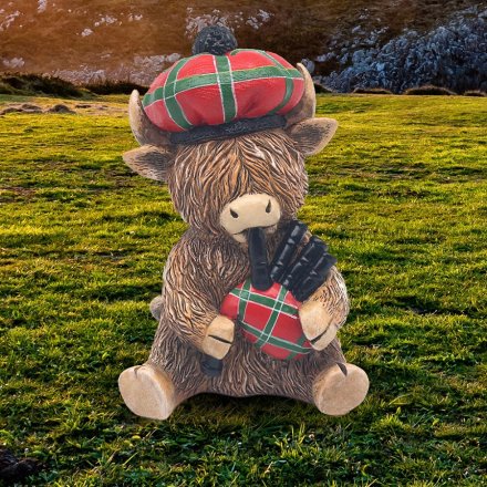 Enjoy Scotland with our Highland Cow Piper Ornament - the perfect accent for your home decor!