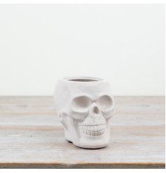 A white skull planter perfect for adding a spooky look to the home.