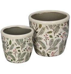 A set of 2 planters, each with an attractive red berry and green foliage pattern. 