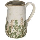 A rustic cream and green decorative jug with distressed worn features and a dark stone coloured rim.