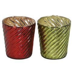 An assortment of 2 green and red antique glass candle holders with a swirl pattern and reflective surface. 