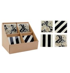A mix of natural and black coasters in bold stripe and floral designs. 