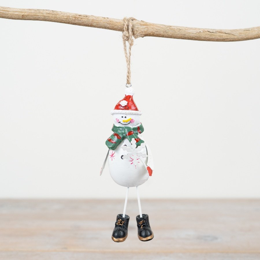 A charming metal snowman hanger with a festive green and red scarf and a delicate snowflake wand.