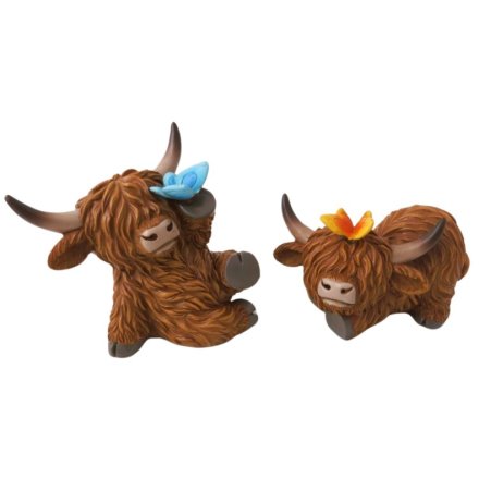 A colourful assortment of 2 highland cows each displayed with colourful butterflies resting on them.