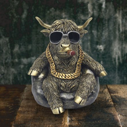 Bring a touch of Scotland to your home with our Highland Cow Chilling figurine