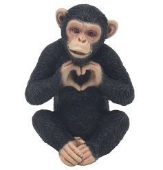 sweet little monkey holding the heart sign 