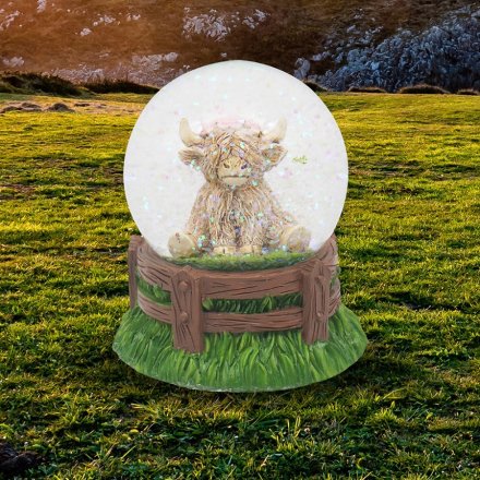 add some scottish flair with this highland cow glitter globe 