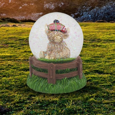 Add a touch of Scottish whimsy to your home with our new Highland Cow Tartan Cap Waterglobe. 