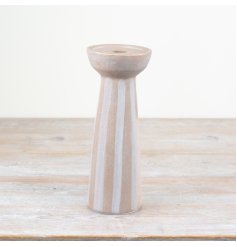 Ceramic candle holder featuring natural hues and delicate striped patterns for an elegant touch.