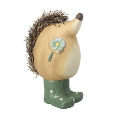 A sweet and happy hedgehog holding a pretty flower whilst stood in a pair of wellingtons.