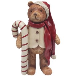 A charming bear ornament with a large candy cane, red scarf and long Santa's hat. 