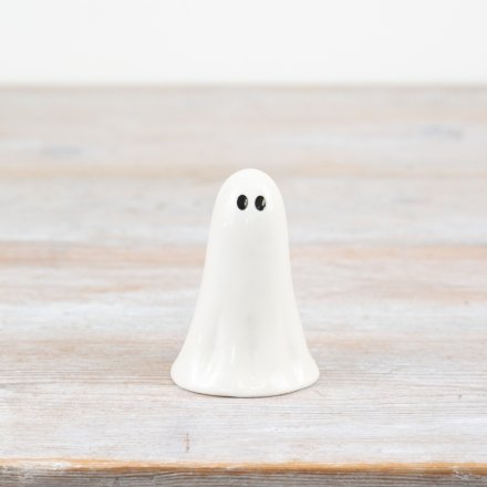 Tiny white ghost decoration, perfect for adding a subtle spooky touch.